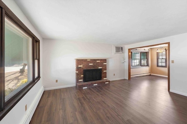 unfurnished living room featuring a brick fireplace, dark wood-style floors, baseboards, and baseboard heating