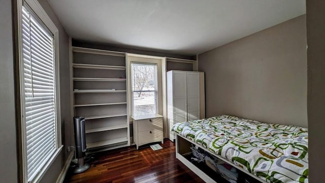 bedroom with dark wood-type flooring