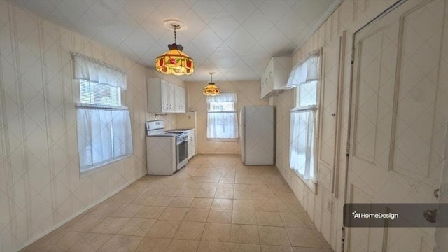 kitchen featuring pendant lighting, tile walls, white range with electric stovetop, white cabinets, and light tile patterned flooring