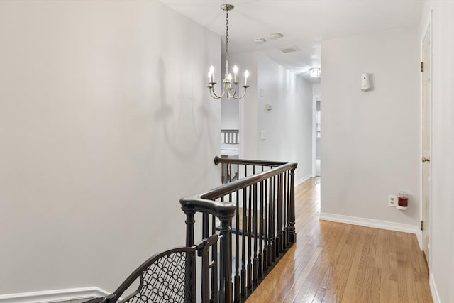 27 N Brigham Hill Rd, Grafton, MA 01536 - corridor featuring an upstairs landing, light wood-style floors, and a chandelier