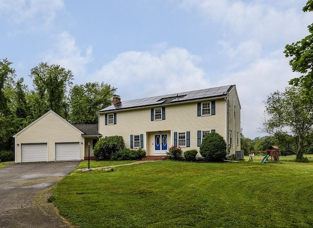 27 N Brigham Hill Rd, Grafton, MA 01536 - colonial home featuring asphalt driveway, a front lawn, solar panels, a garage, and a chimney