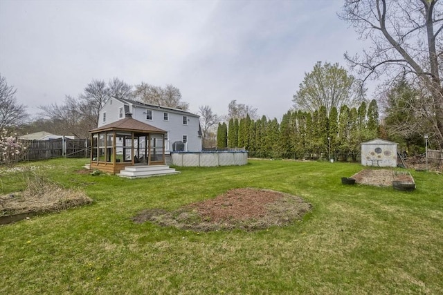 view of yard with a fenced backyard, a wooden deck, a gazebo, and an outdoor pool