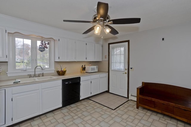kitchen with black dishwasher, light countertops, a sink, and white microwave