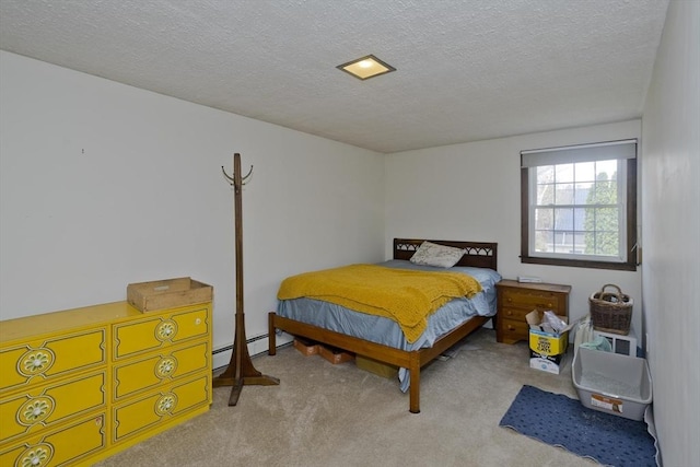 carpeted bedroom with a baseboard radiator and a textured ceiling