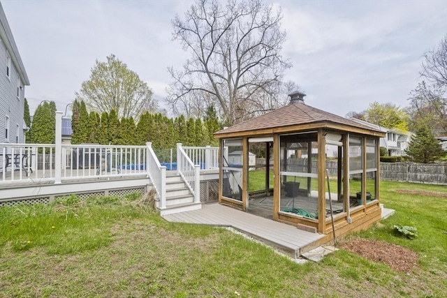 exterior space featuring fence and a deck