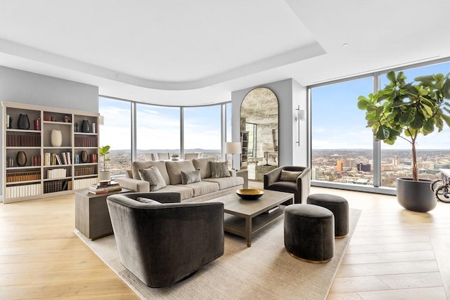 living room featuring expansive windows and light wood-type flooring