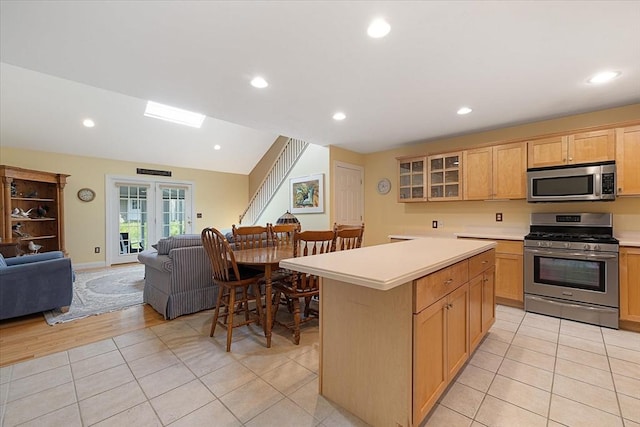 3 Angell Brook Dr Unit 3, West Boylston, MA 01583 - kitchen featuring appliances with stainless steel finishes, open floor plan, light countertops, a kitchen island, and glass insert cabinets
