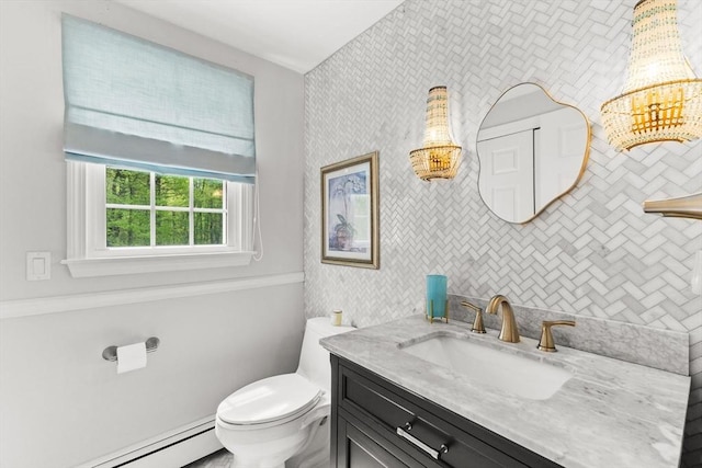 bathroom with baseboard heating, toilet, and vanity