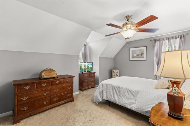 bedroom with light carpet, a ceiling fan, baseboards, and lofted ceiling