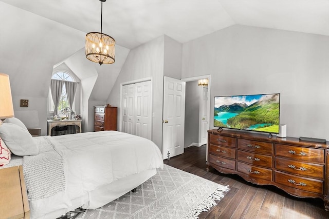 bedroom with a chandelier, lofted ceiling, wood-type flooring, and a closet