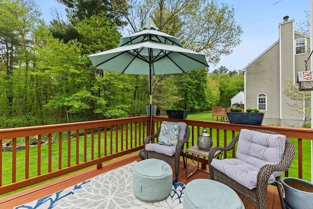 wooden terrace with a lawn