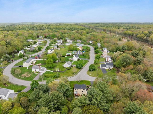 aerial view of property's location with a heavily wooded area and nearby suburban area