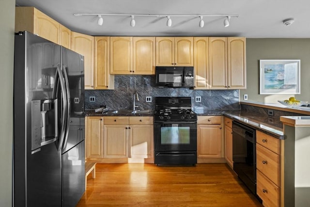 kitchen with sink, light brown cabinets, tasteful backsplash, light hardwood / wood-style flooring, and black appliances