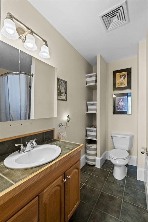 bathroom with curtained shower, tile patterned flooring, vanity, and toilet