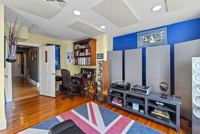 home office with dark hardwood / wood-style flooring