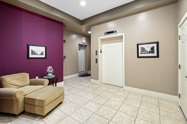 interior space featuring elevator and light tile patterned flooring