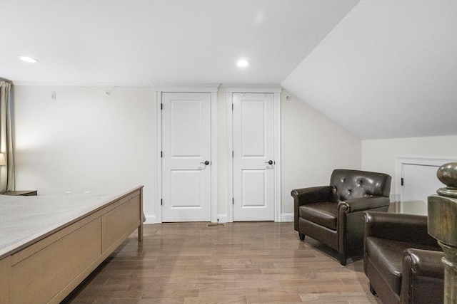 sitting room with light wood-style floors, recessed lighting, baseboards, and lofted ceiling