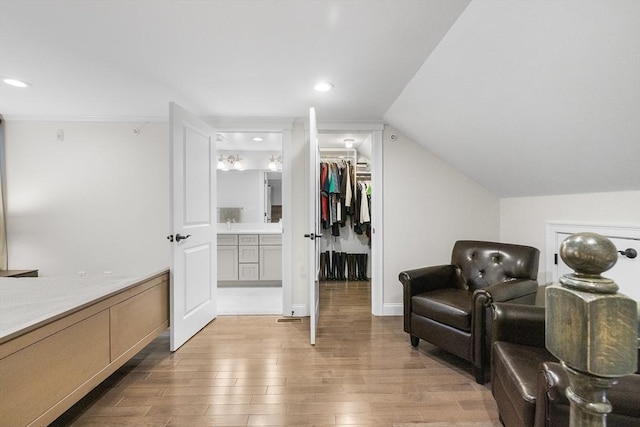 living area with light wood-type flooring and recessed lighting