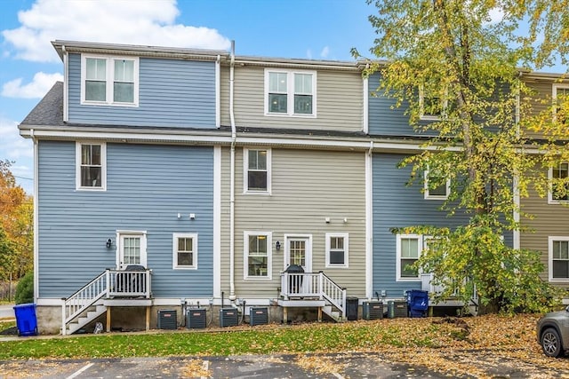 back of property with uncovered parking and central air condition unit