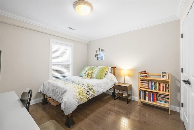 bedroom with baseboards, ornamental molding, and wood-type flooring