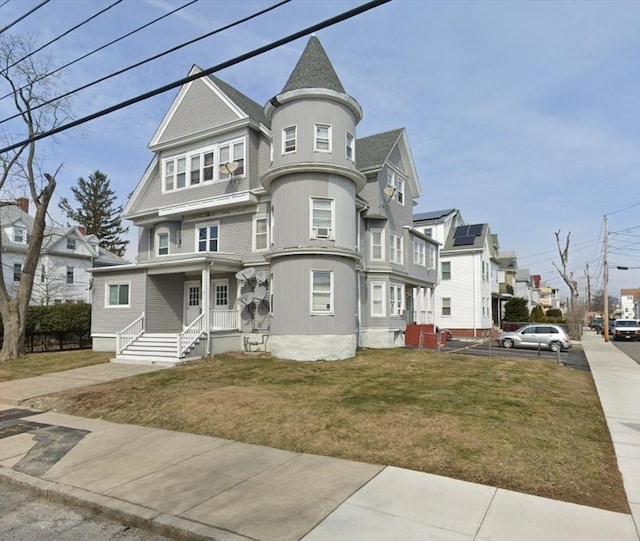 view of front of home featuring a front lawn and a residential view