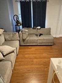living area with wood finished floors and baseboards