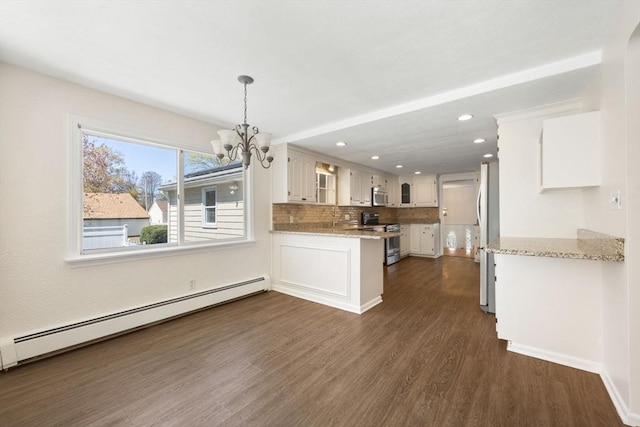 kitchen with stainless steel appliances, a baseboard radiator, a chandelier, a peninsula, and dark wood-style flooring