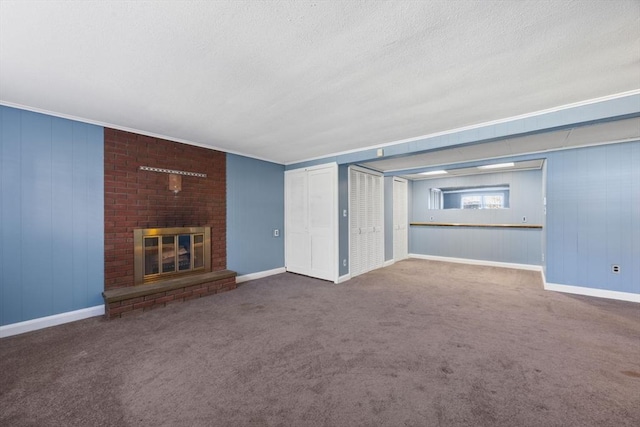 unfurnished living room featuring a textured ceiling, carpet, a brick fireplace, and baseboards