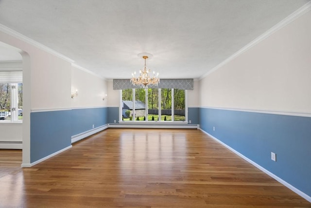 unfurnished dining area featuring a baseboard radiator, a chandelier, wood finished floors, ornamental molding, and baseboards