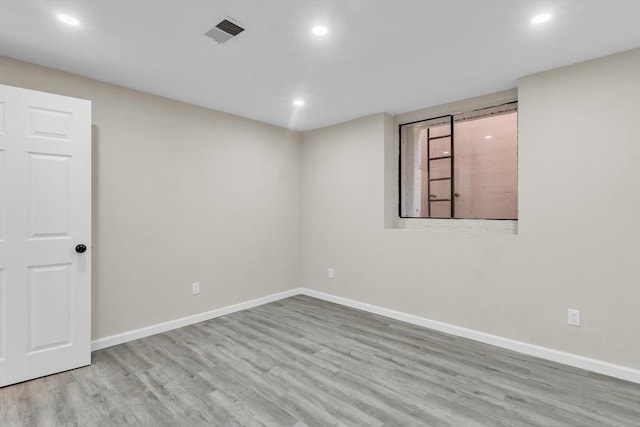 unfurnished room with light wood-type flooring