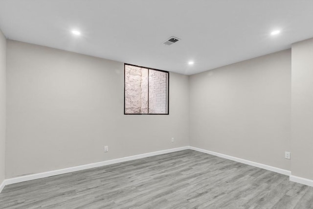 spare room with light hardwood / wood-style flooring