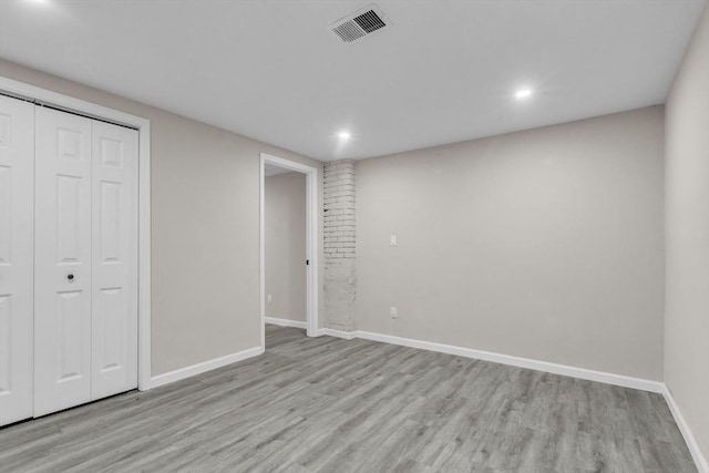 unfurnished bedroom with light hardwood / wood-style flooring and a closet