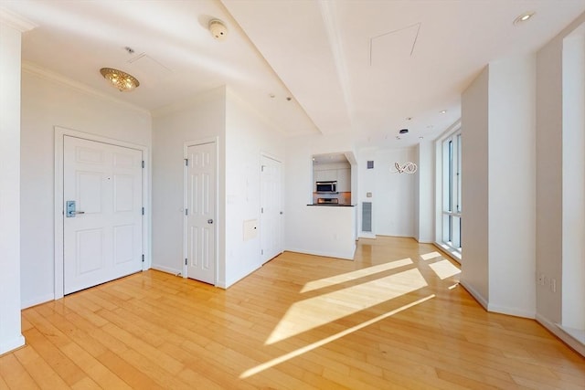 interior space with hardwood / wood-style flooring and crown molding