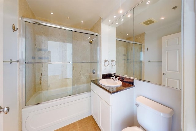 full bathroom with tile patterned flooring, vanity, toilet, and bath / shower combo with glass door