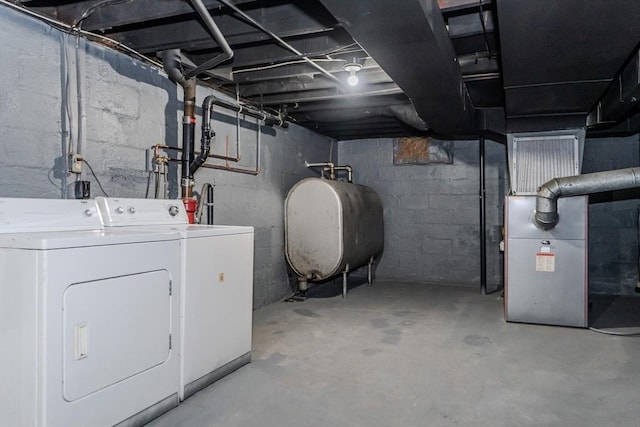 basement featuring washer and dryer and heating unit