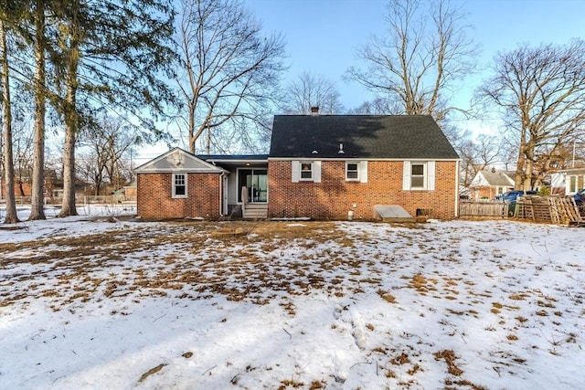 view of snow covered rear of property