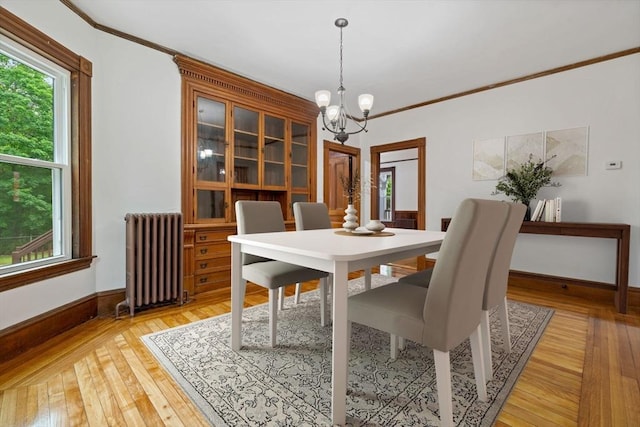 42 Middlesex St, Chelmsford, MA 01863 - dining room with radiator heating unit, a chandelier, light wood-style flooring, crown molding, and baseboards