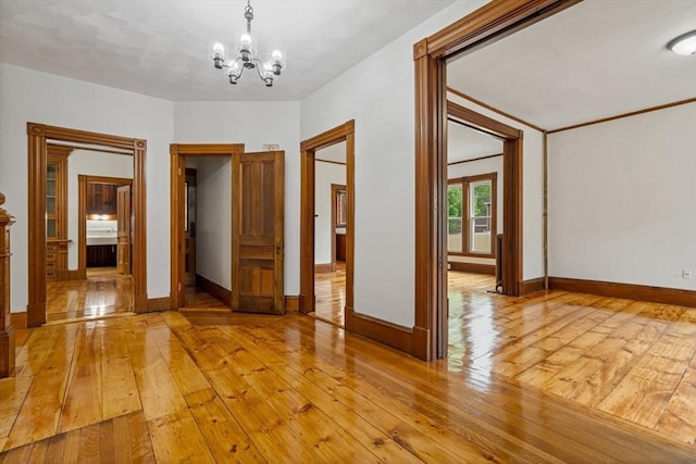42 Middlesex St, Chelmsford, MA 01863 - unfurnished room featuring a chandelier, light wood-type flooring, and baseboards