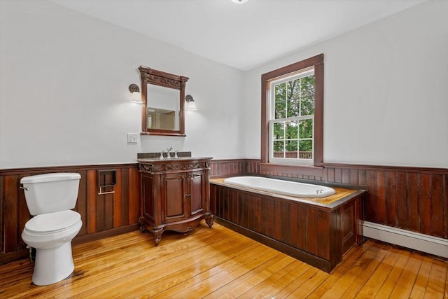 42 Middlesex St, Chelmsford, MA 01863 - full bathroom with wainscoting, a garden tub, hardwood / wood-style flooring, vanity, and toilet