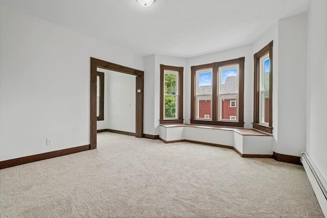 42 Middlesex St, Chelmsford, MA 01863 - empty room featuring a baseboard heating unit, light colored carpet, and baseboards