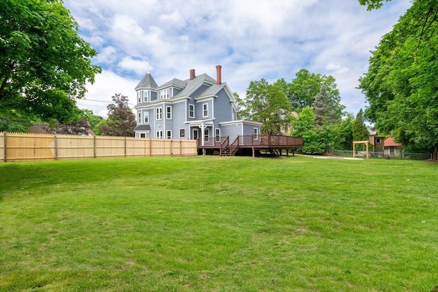 42 Middlesex St, Chelmsford, MA 01863 - rear view of property with a wooden deck and a chimney