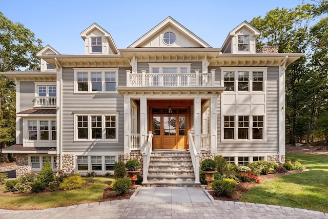 view of front facade with a balcony and a porch