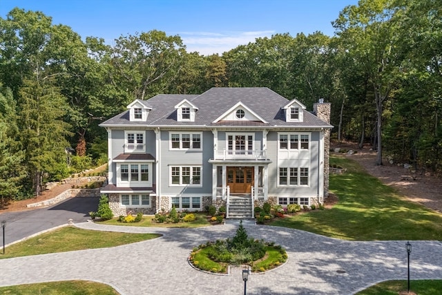 view of front of house featuring covered porch and a front yard