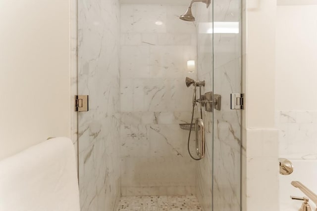 full bath featuring a marble finish shower