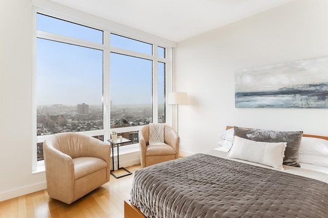 bedroom with baseboards and wood finished floors