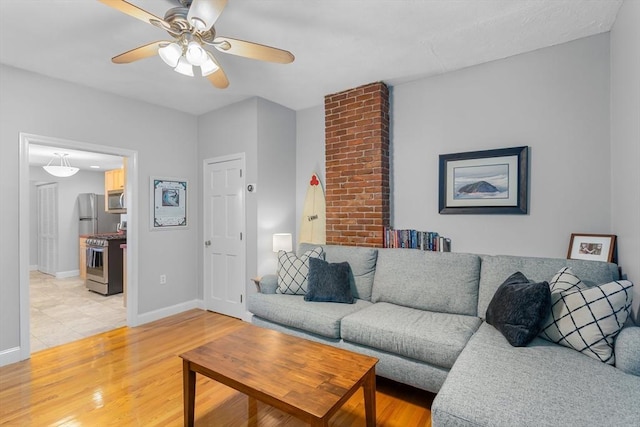 living room featuring ceiling fan and light wood-type flooring