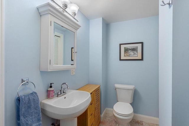 bathroom featuring toilet and sink