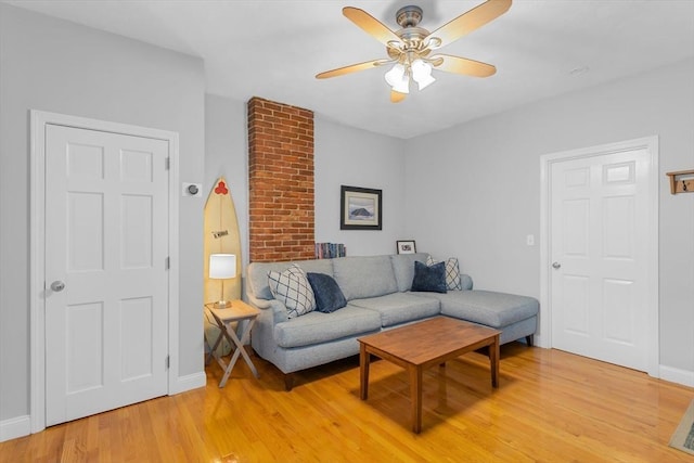 living room with ceiling fan and light wood-type flooring