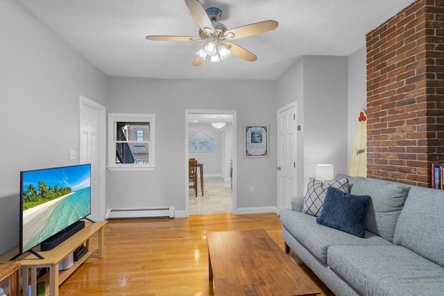 living room featuring baseboard heating, ceiling fan, and light wood-type flooring