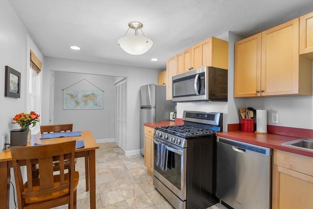 kitchen with light brown cabinets and stainless steel appliances